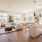 open kitchen with under cabinet lighting and access to living room