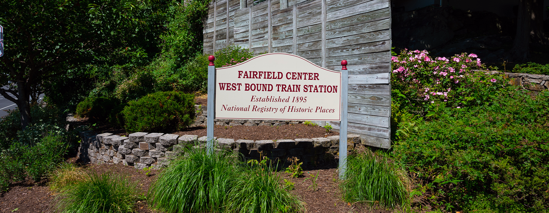 outside image of "Fairfield Center West Bound Train Station" wooden sign.  